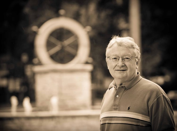 The late Dr. Gene Carpenter next to the helm at Bethel College, Mishawaka, Indiana