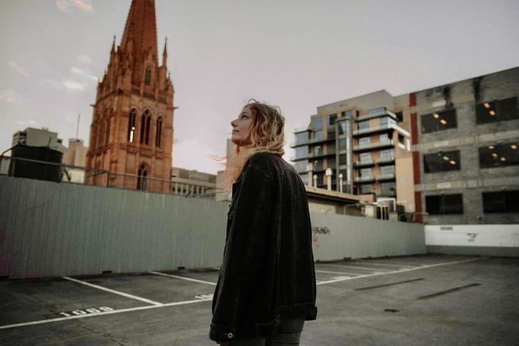A woman looking looking at a church cathedral.